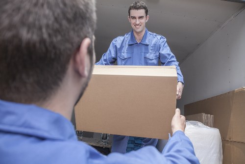 Furniture pick-up service removing a sofa in Homerton