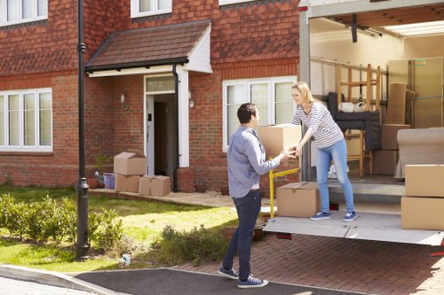 Flat removals in Homerton with moving boxes and furniture in an apartment building