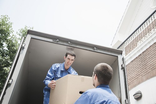 Moving team preparing bulky furniture for transport in Homerton